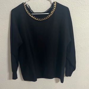 Black shirt with gold chain around neck. No rips, pet free/ smoke free home